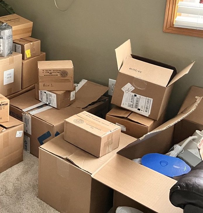 Cardboard boxes of donated supplies packed for Kanchipuram, one labeled Box 1